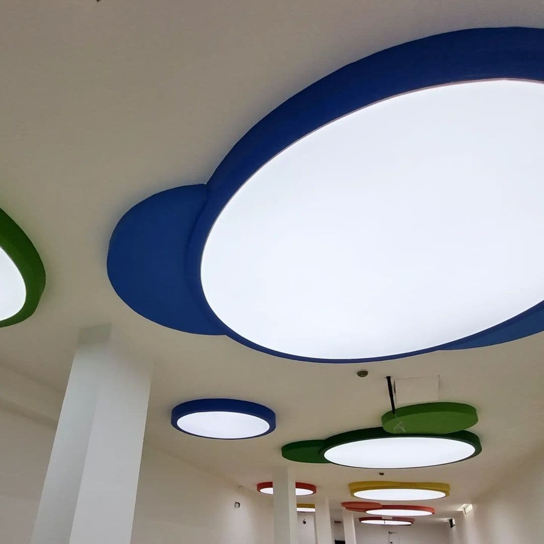 Backlit oval ceiling forms with blue and green surrounds