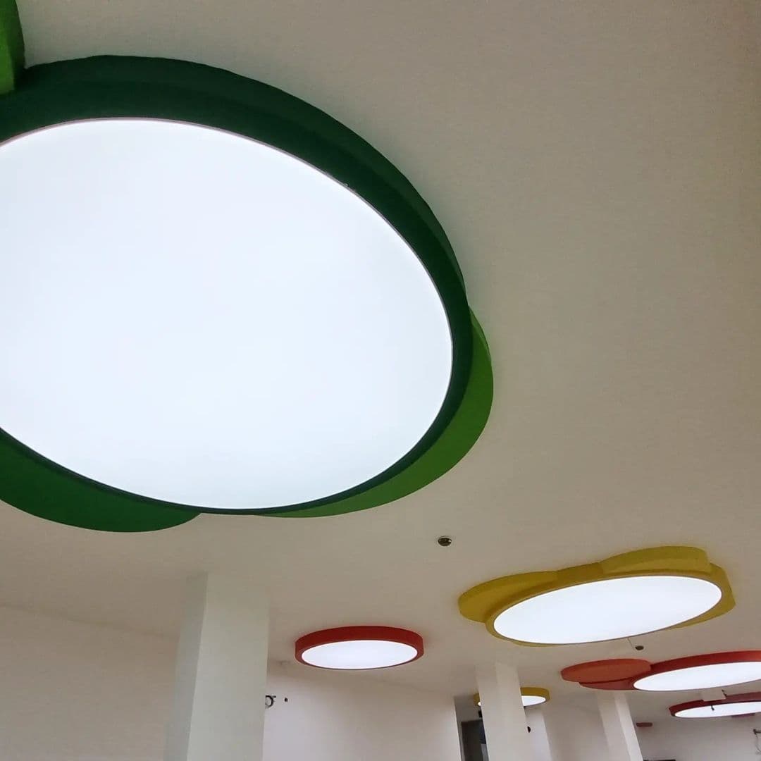 Close view of backlit oval ceiling forms