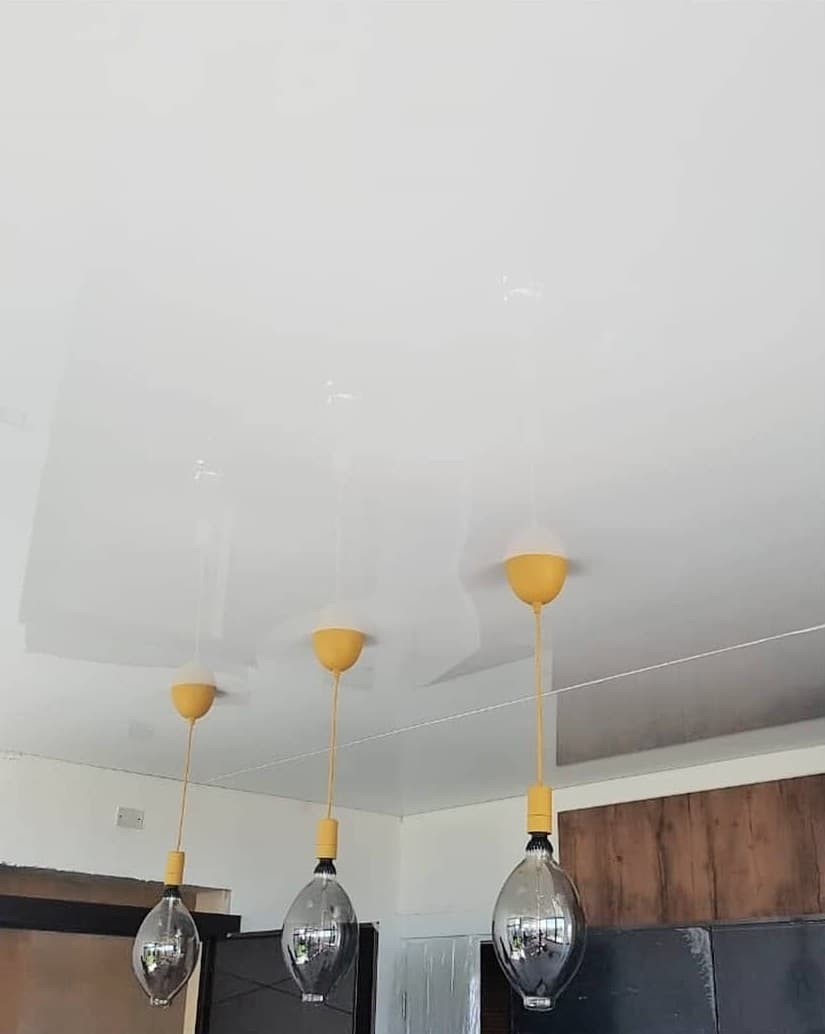White gloss ceiling with three pendant lights