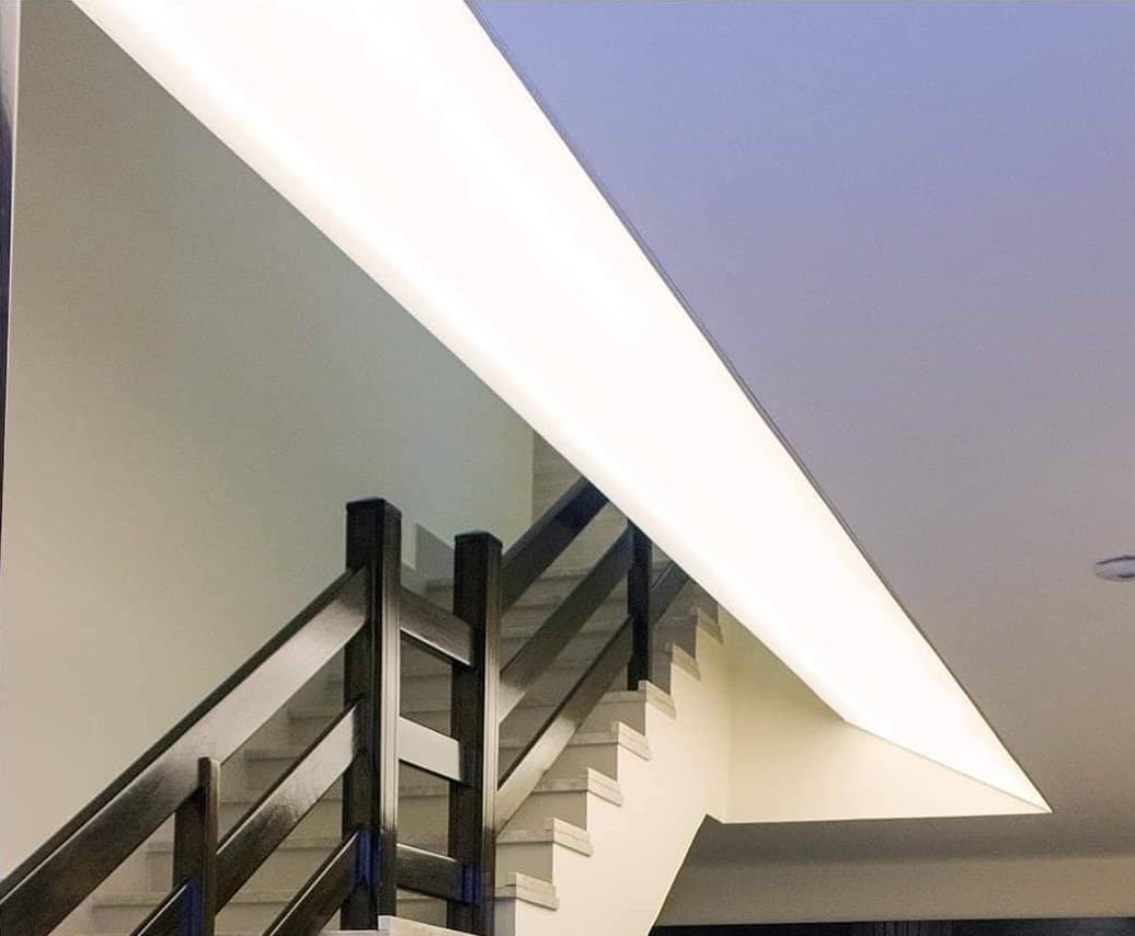 Staircase ceiling with a long recessed light line