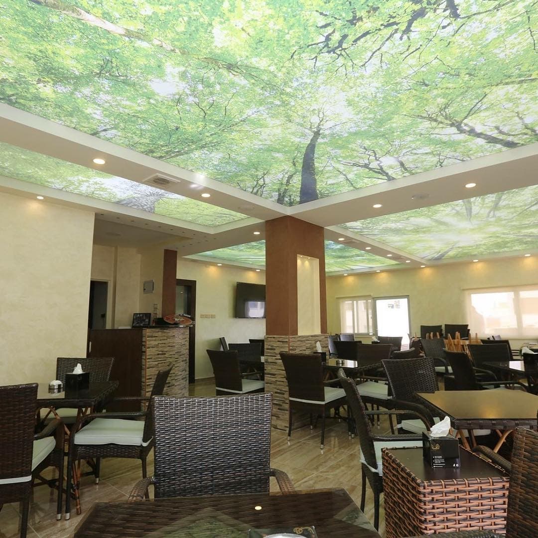 Restaurant with a printed tree-canopy ceiling