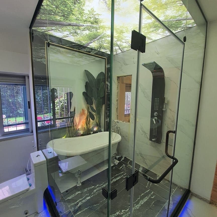 Bathroom shower enclosure under a printed leaf ceiling