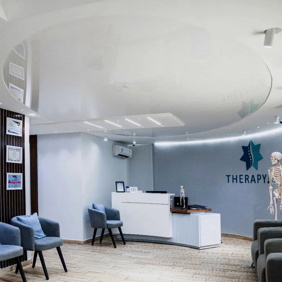 Clinic reception with a white gloss ceiling and cove lighting
