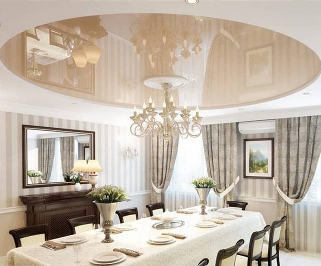 Formal dining room under an oval cream gloss ceiling