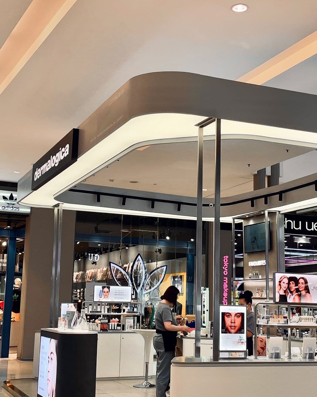 Retail kiosk with a white stretch ceiling canopy and display lighting