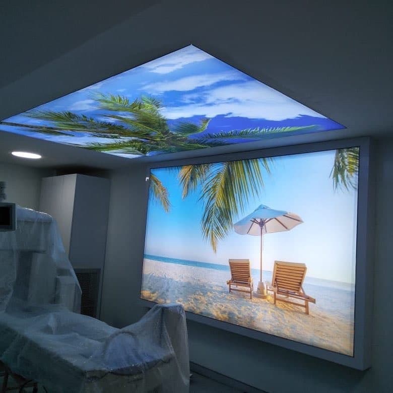 Backlit beach-print wall light box with a matching printed ceiling