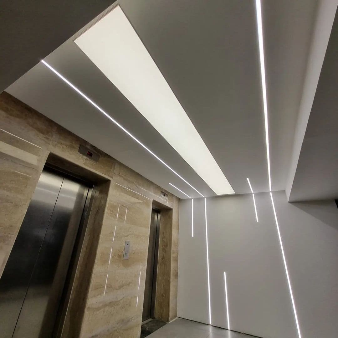 Lift lobby with linear light lines running across ceiling and walls