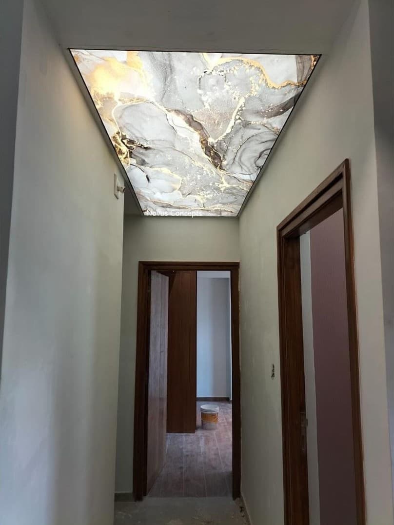 Corridor with a marble-effect printed ceiling panel