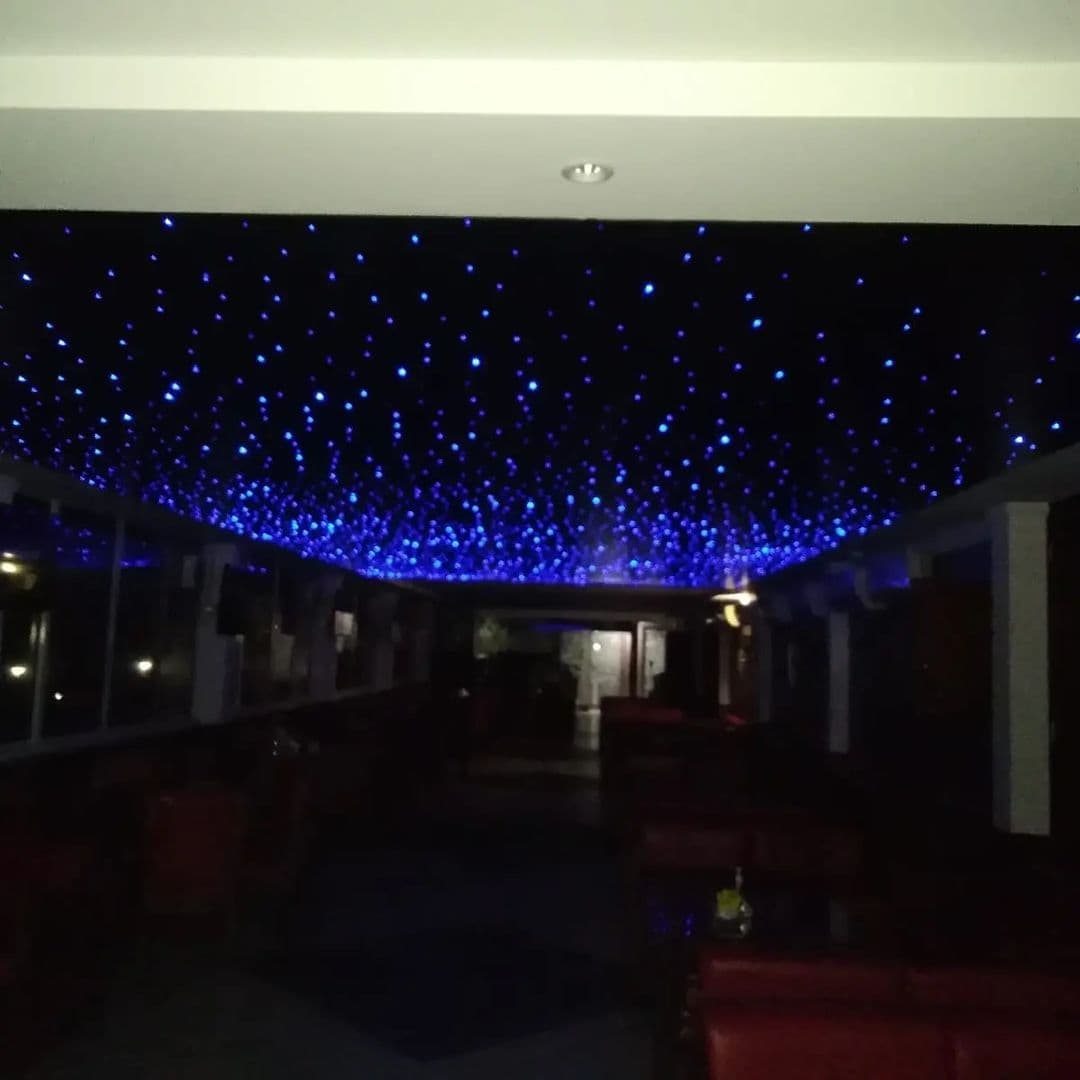 Lounge with a starry ceiling above red seating