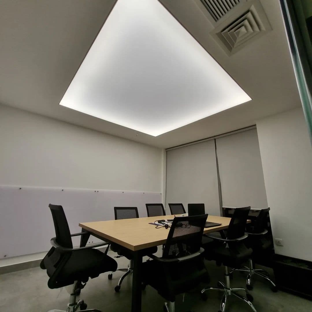 Boardroom with a soft glowing translucent ceiling and cove edges