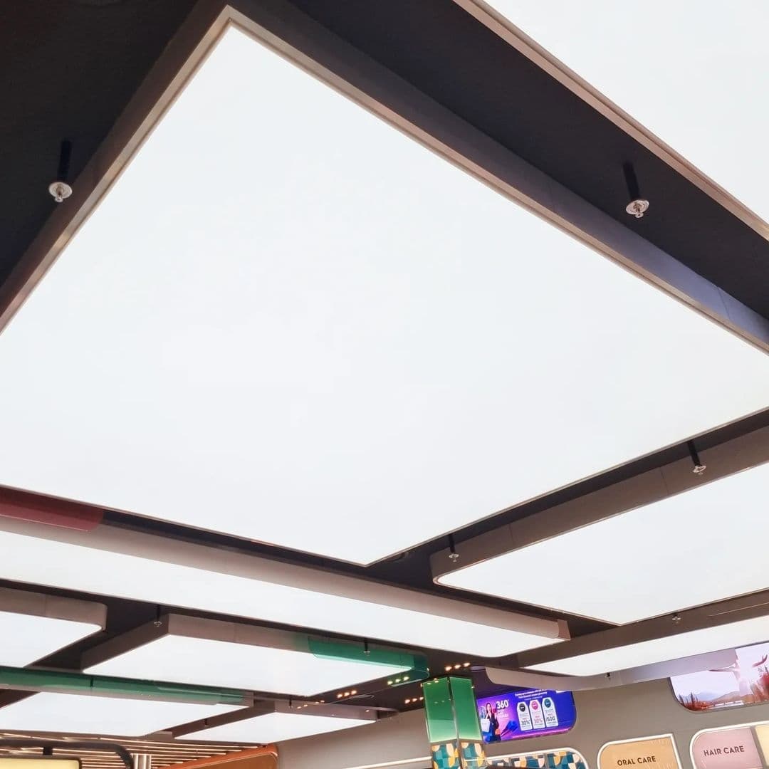 Large translucent backlit panels set within dark ceiling frames